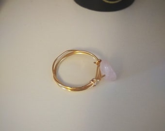 May include: A gold wire ring with a pink rose quartz stone attached.