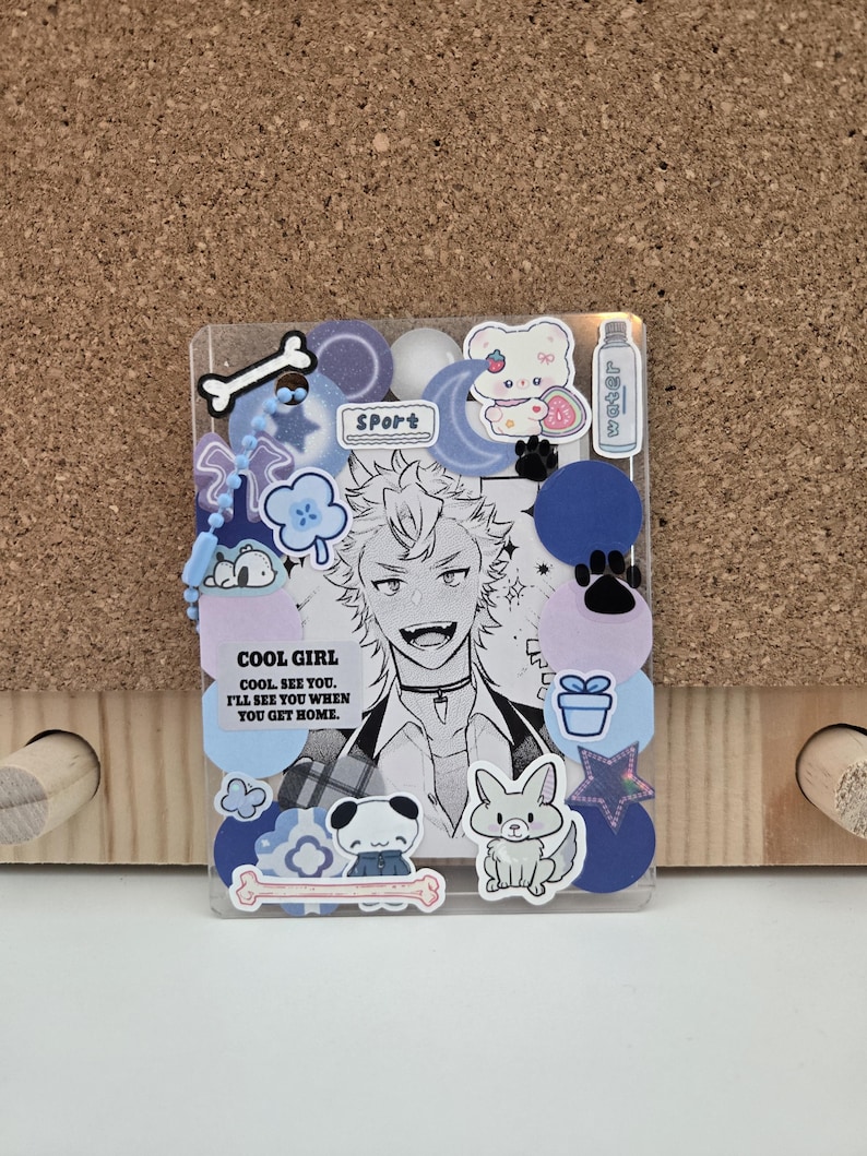 May include: Clear, rectangular phone case decorated with stickers. The stickers include a black and white anime-style character, cartoon animals, and the text "COOL GIRL. COOL. SEE YOU. I'LL SEE YOU WHEN YOU GET HOME."