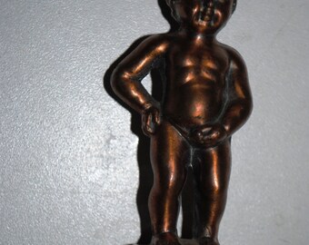 Old metal figure of a boy peeing