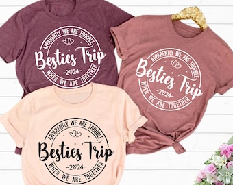 May include: Three pink and peach t-shirts with a white circle design that says "Apparently we are trouble Besties Trip -2024- When we are together".