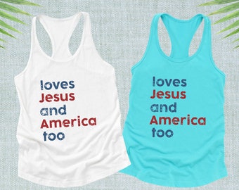 May include: Two tank tops with the text "loves Jesus and America too" printed on them. The tank top on the left is white and the tank top on the right is blue.