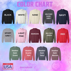 The image is a color chart displaying various colored sweatshirts, each with a different color and design.