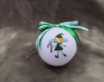 A Christmas ball with an enchanting fairy holding a staff