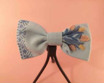 Blue bow with charming flowers and ornaments