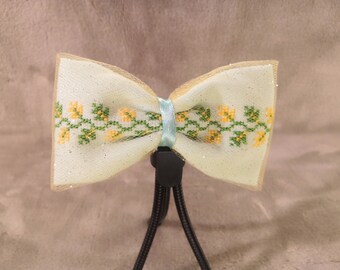 Pale green bow with yellow-green flower vine