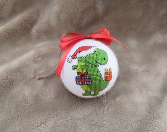 Christmas tree ornament with a dragon in a Santa hat and gifts