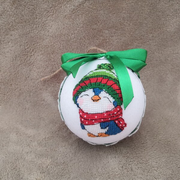 Christmas ornament with an adorable penguin in a cap and scarf