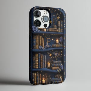 May include: A navy blue phone case featuring a bookshelf design with books, candles, and floral accents. The case has a starry night background with gold stars and a letter "E". The case is designed to fit a smartphone.