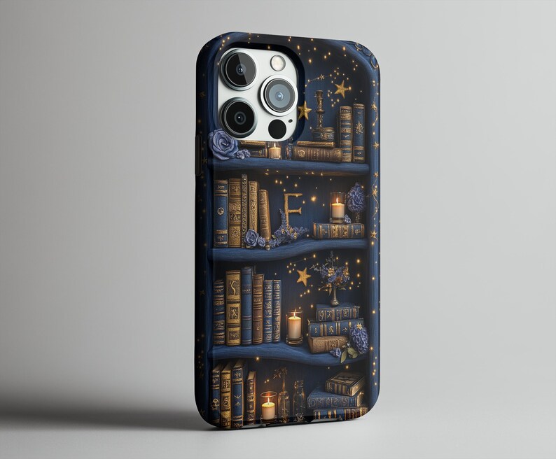 May include: A navy blue phone case featuring a bookshelf design with books, candles, and floral accents. The case has a starry night background with gold stars and a letter "E". The case is designed to fit a smartphone.