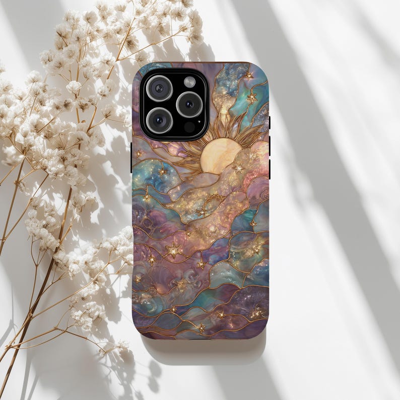 Puede incluir: Funda de tel&eacute;fono con un dise&ntilde;o celestial. El dise&ntilde;o presenta un sol, estrellas y nubes en tonos morados, azules y dorados. La funda tiene un acabado brillante y un dise&ntilde;o protector. Un accesorio elegante.