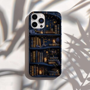 May include: A navy blue phone case featuring a detailed illustration of a bookshelf. The design includes stacks of antique books, candles, and floral accents. The background is a starry night sky with golden stars.