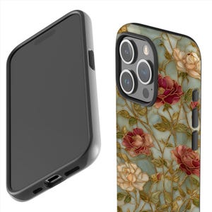 May include: A black smartphone case with a floral design. The case features a pattern of red, cream, and gold flowers on a teal background. The phone's camera lenses are visible.