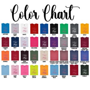 May include: A color chart displays various t-shirt colors, including sapphire, red, and black. The chart features a range of hues, from light blue to forest green, with each color labeled for easy reference. The text "Color Chart" is at the top.