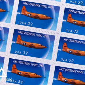 May include: Sheet of postage stamps featuring an orange airplane against a blue sky. The stamps commemorate the "FIRST SUPERSONIC FLIGHT 1947" and are marked "USA 32". The design includes a star and bar insignia on the plane's wing.