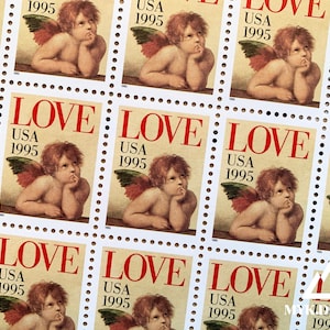 May include: A sheet of 10 US postage stamps featuring a cherub with wings, each stamp says "LOVE" and "USA 1995" in red lettering.