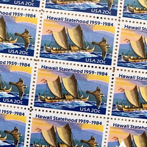 May include: A sheet of five vintage US postage stamps commemorating the 1959 statehood of Hawaii. Each stamp features a colorful illustration of a traditional Hawaiian canoe with a bird flying overhead. The text "USA 20c" and "Hawaii Statehood 1959-1984" are printed on each stamp.