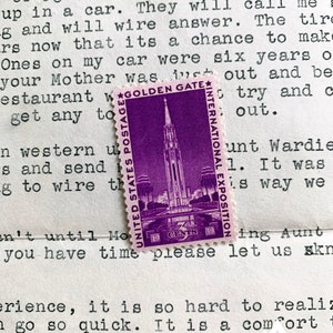 May include: A purple and white vintage postage stamp with the text "Golden Gate International Exposition" and "United States Postage 3 Cents".