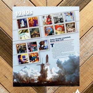 May include: A sheet of 15 stamps commemorating the 1980s, featuring images related to technology, entertainment, and science. The stamps include a space shuttle launch, pop culture figures, and historical events. The text "15 STAMPS" is at the top.