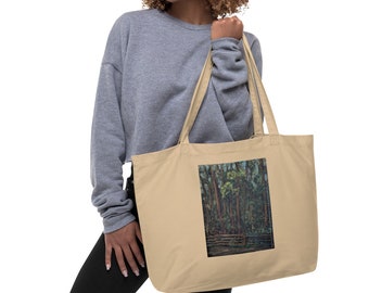 May include: A beige tote bag with a forest scene printed on the front. The scene features tall trees with green leaves and a wooden fence in the foreground.