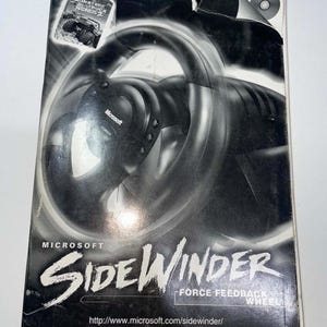 May include: A black and white product manual for the Microsoft SideWinder Force Feedback Wheel. The cover features a large image of the steering wheel, a small Monster Truck Madness 2 graphic, and the URL http://www.microsoft.com/sidewinder/.