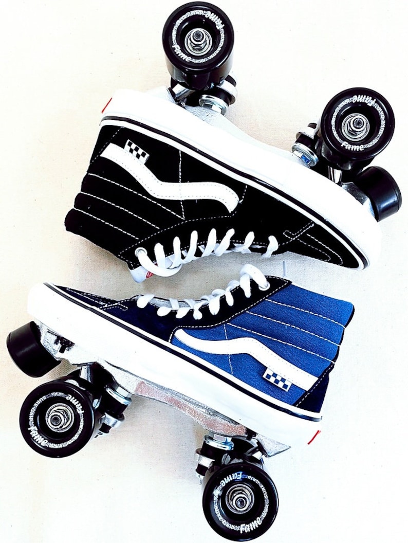 May include: A pair of black and blue high-top Vans sneakers with white checkerboard accents, modified into roller skates with black wheels and silver frames.