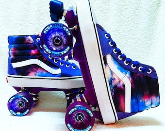 May include: Purple roller skates with galaxy print on the boots and wheels. The wheels have blue lettering that says "Pure Ice Grip".