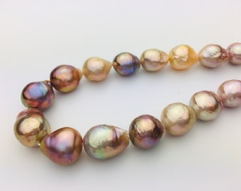 May include: A strand of iridescent baroque pearls in shades of purple, gold, and cream. The pearls are irregularly shaped and strung together, creating a unique and elegant necklace.