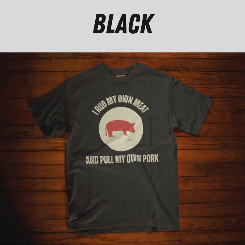 May include: A dark gray t-shirt with a white circle and a red pig silhouette. The text "I rub my own meat and pull my own pork" is printed on the shirt.