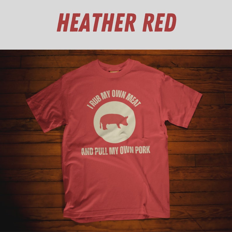 May include: Heather red t-shirt with a white graphic that says "I rub my own meat and pull my own pork" with a pig silhouette inside a circle.