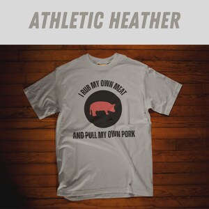 May include: A gray t-shirt with the text "I rub my own meat and pull my own pork" and a silhouette of a pig in a circle.