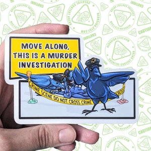 May include: A sticker with a yellow and black warning sign that reads "Move along, this is a murder investigation."  A blue bird with a police hat stands on a yellow crime scene tape with a blue bird lying on the ground.  The sticker has a white background.