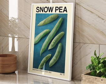 May include: A framed poster with a blue background and a white border. The poster features a vintage illustration of snow peas with the text "SNOW PEA" in bold black letters. The text "BAUHAUS COLLECTION 1952" and "NO. 14" are printed in black at the bottom of the poster.