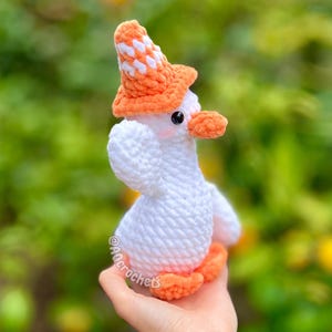 silly goose crochet pattern, low sew silly goose crochet pattern, amigurumi goose, goose wearing traffic cone hat, goose wearing frog hat, goose wearing flower hat, amigurumi bird pattern, cute crochet pattern
