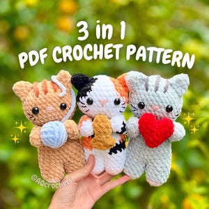 May include: Three crocheted cat toys in a row, each with unique features. One is tan with a blue yarn ball, another is white with orange and black markings, and the last is gray holding a red heart. The text "3 in 1 PDF CROCHET PATTERN" is above them.