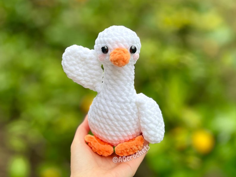 silly goose crochet pattern, low sew silly goose crochet pattern, amigurumi goose, goose wearing traffic cone hat, goose wearing frog hat, goose wearing flower hat, amigurumi bird pattern, cute crochet pattern