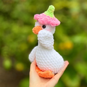 silly goose crochet pattern, low sew silly goose crochet pattern, amigurumi goose, goose wearing traffic cone hat, goose wearing frog hat, goose wearing flower hat, amigurumi bird pattern, cute crochet pattern