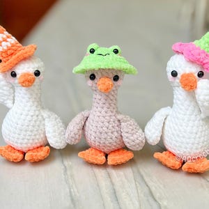 silly goose crochet pattern, low sew silly goose crochet pattern, amigurumi goose, goose wearing traffic cone hat, goose wearing frog hat, goose wearing flower hat, amigurumi bird pattern, cute crochet pattern