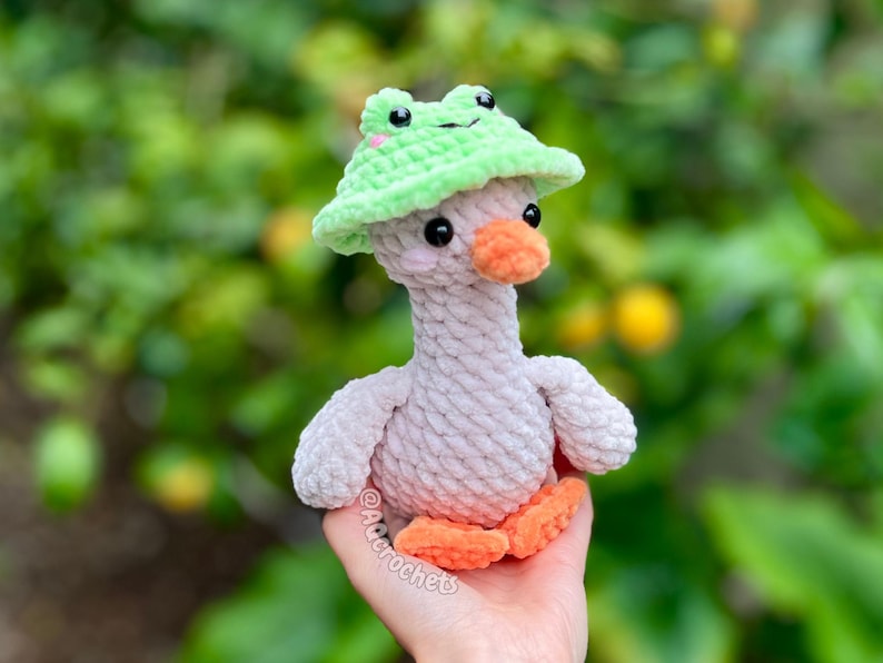 silly goose crochet pattern, low sew silly goose crochet pattern, amigurumi goose, goose wearing traffic cone hat, goose wearing frog hat, goose wearing flower hat, amigurumi bird pattern, cute crochet pattern