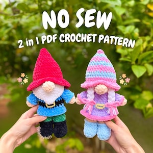 May include: Two crocheted plush dolls, one with a red hat and blue outfit, the other with a pink and blue striped hat and purple dress. Text reads NO SEW 2 in 1 PDF CROCHET PATTERN. The dolls feature yarn beards or braids and small noses.