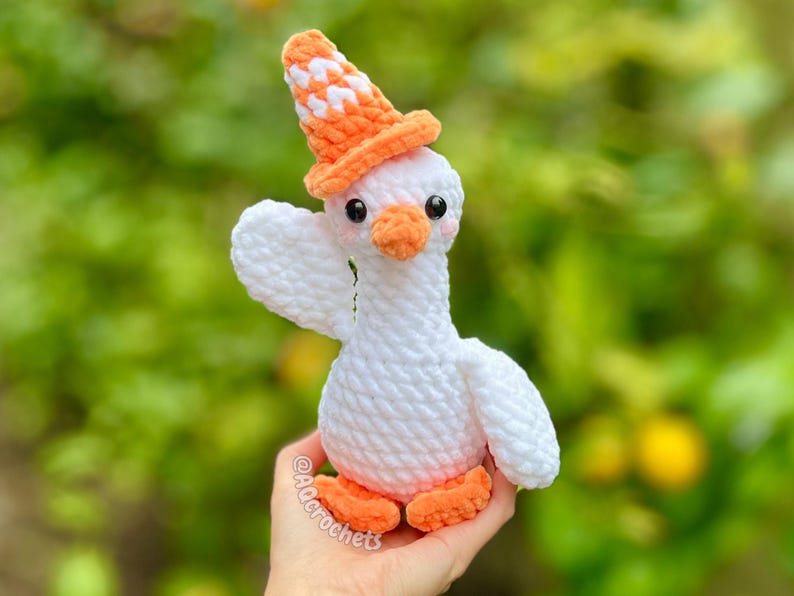 silly goose crochet pattern, low sew silly goose crochet pattern, amigurumi goose, goose wearing traffic cone hat, goose wearing frog hat, goose wearing flower hat, amigurumi bird pattern, cute crochet pattern