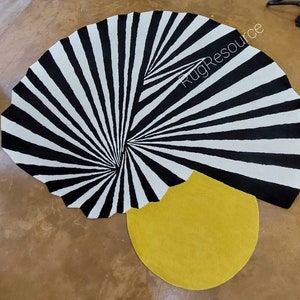 May include: A black and white striped round rug with a yellow circle in the centre. The rug has a spiral design and the text "RugResource" is visible in the top right corner.