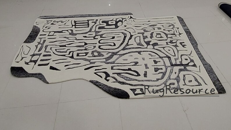 May include: Abstract black and white area rug with a unique, modern design. The rug has a slightly irregular shape and features a black border. The text "RugResource" is visible in the lower right corner.