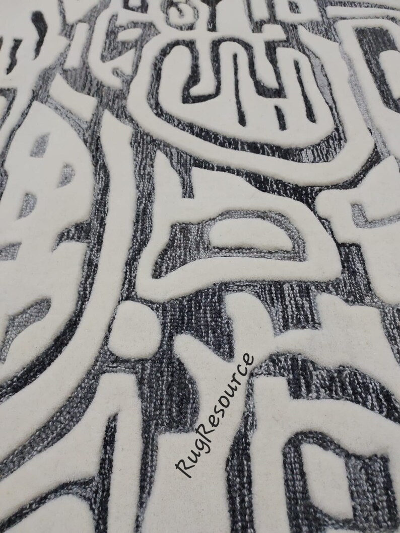 May include: Close-up of a white and gray rug with a textured, abstract design. The rug has a raised, 3D effect, creating a unique and modern look. The text "RugResource" is visible in the lower right corner of the image.