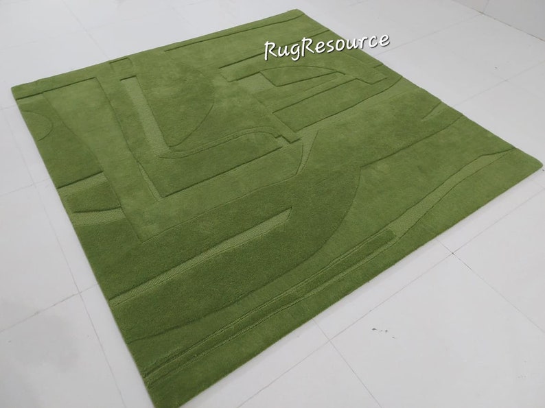 May include: A green shag rug with a geometric pattern. The rug has a raised texture and is made of soft, plush fibers.