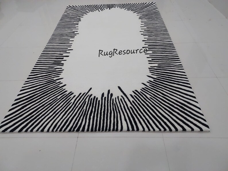 May include: Black and white rug with a large oval shape in the center. The oval is surrounded by black lines radiating outward. The text "RugResource" is visible in the center of the oval.