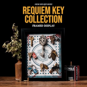May include: A framed display featuring a collection of antique keys. The keys are arranged on a patterned background within a black frame. The text "REQUIEM KEY COLLECTION FRAMED DISPLAY" is at the top. A vase with dried plants and a box of bullets are also in the image.