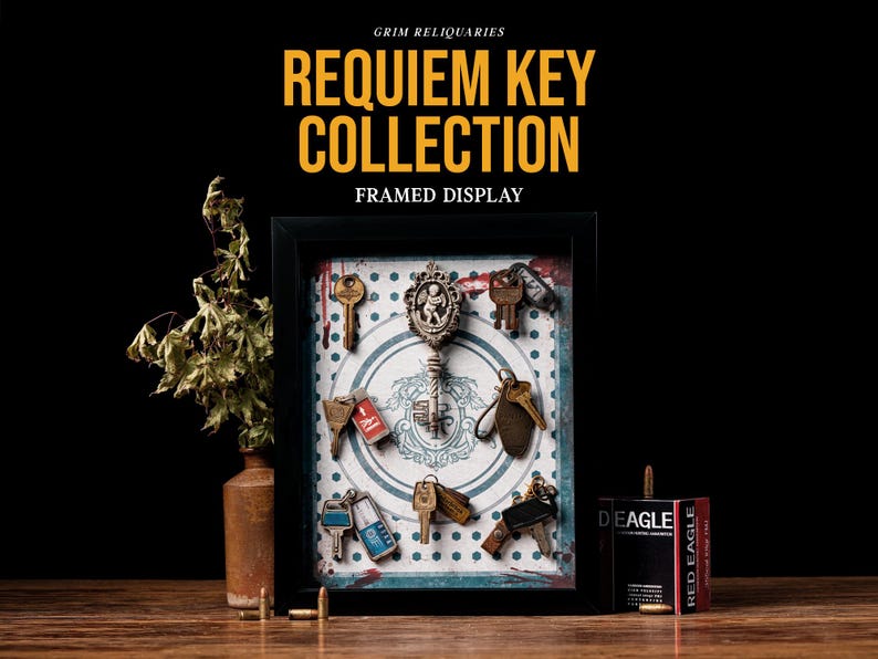 May include: A framed display featuring a collection of antique keys. The keys are arranged on a patterned background within a black frame. The text "REQUIEM KEY COLLECTION FRAMED DISPLAY" is at the top. A vase with dried plants and a box of bullets are also in the image.