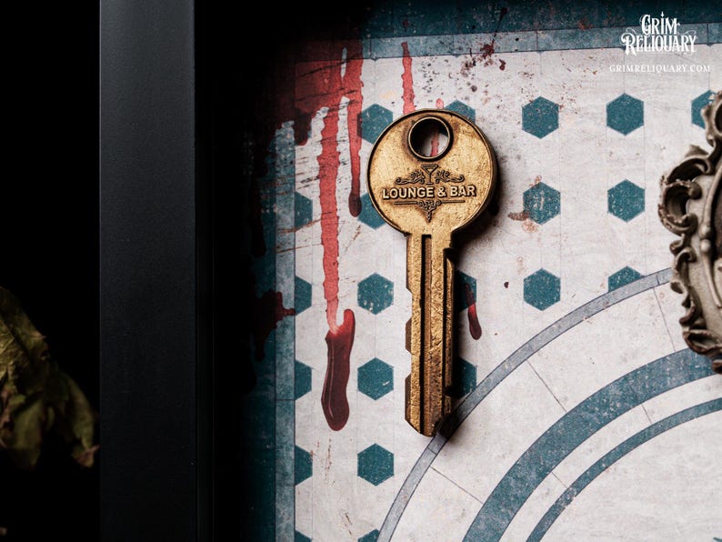 May include: A vintage-style key with "LOUNGE & BAR" text, set against a backdrop of a patterned surface with red streaks. The key is gold-toned, and the background has a geometric design with blue and white shapes.