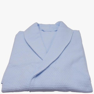 May include: A light blue waffle weave robe with a shawl collar.