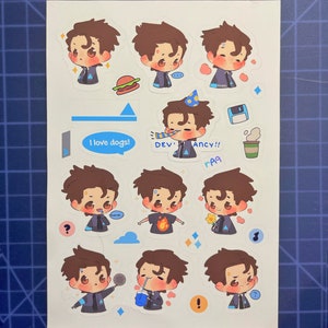 May include: A sheet of stickers featuring a cartoon character with brown hair and blue eyes. The character is shown in various poses and expressions, including wearing a party hat, holding a flower, and holding a microphone. The stickers are printed on white paper and have a glossy finish.